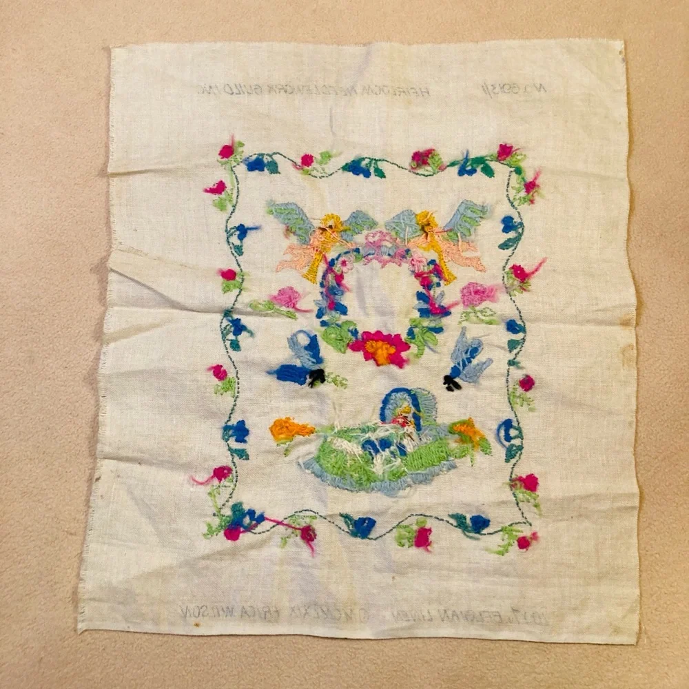 Beautiful small sampler of newborn child, knitted in colorful needlework linen